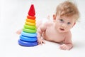 Cute baby boy with toy pyramid on light background Royalty Free Stock Photo