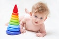 Cute baby boy with toy pyramid on light background Royalty Free Stock Photo