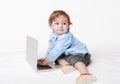 Cute baby boy typing on laptop keyboard Royalty Free Stock Photo