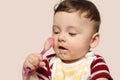 Cute baby boy wanting to eat baby food with the spoon. Royalty Free Stock Photo