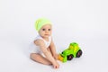 Cute baby boy in a white bodysuit on a white isolated background playing with a typewriter, early development of children, baby 8 Royalty Free Stock Photo