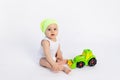 Cute baby boy in a white bodysuit on a white isolated background playing with a typewriter, early development of children, baby 8 Royalty Free Stock Photo