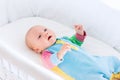 Cute baby boy in a white crib Royalty Free Stock Photo