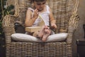 Cute baby in a chair reading a book in interior Royalty Free Stock Photo