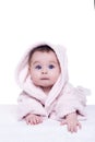 Cute baby child in pink bathrobe lying down on blanket Royalty Free Stock Photo