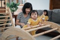 cute baby climbing pikler climbing toys with his mother