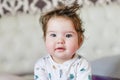 Cute baby, close up. Portrait of a crawling baby on the bed in her room