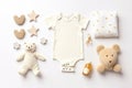 Cute baby clothes for boy and girl, rattle, bottle and dummy space in the middle, on white background top view. AI Royalty Free Stock Photo