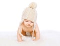 Cute baby in comfort knitted hat crawling