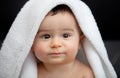 Cute baby covered with white blanket