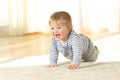 Cute baby crawling and laughing on the floor Royalty Free Stock Photo