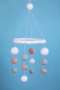 Cute baby crib mobile on light blue background Royalty Free Stock Photo