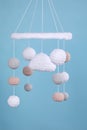 Cute baby crib mobile on light blue background Royalty Free Stock Photo