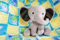 Cute Baby Elephant Stuffed Animal on Colorful Quilt Close Up