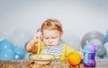 Cute baby food, babies eating. Funny kid boy with plate and spoon. Royalty Free Stock Photo