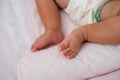cute baby foot on top of soft pink pillow, baby using diapers Royalty Free Stock Photo