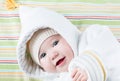 Cute baby in a funny hat on a colorful blanket Royalty Free Stock Photo