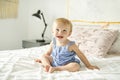 Cute baby girl on bed at home