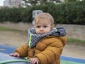 Beautiful baby girl in winter jacket and scarf Royalty Free Stock Photo