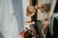 Cute baby girl and boy playing,hiding behind curtains at home. Royalty Free Stock Photo