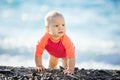 Cute baby girl crawling on beach Royalty Free Stock Photo