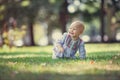 Cute baby girl crawling on lawn in park Royalty Free Stock Photo