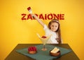 Cute baby girl with dessert and zabaione inscription. Royalty Free Stock Photo