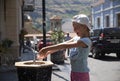 Cute baby girl drinking from water drinking fountain in summer Royalty Free Stock Photo