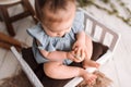 Cute baby girl on Easter set in a studio wearing a blue onsie Royalty Free Stock Photo