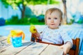 Cute baby girl eating apple at home Royalty Free Stock Photo