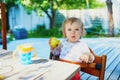 Cute baby girl eating apple at home Royalty Free Stock Photo