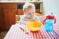 Cute baby girl eating lunch in the kitchen Royalty Free Stock Photo