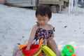 Cute baby girl enjoying sand toys on the beach. Royalty Free Stock Photo