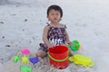 Cute baby girl enjoying sand toys on the beach. Royalty Free Stock Photo