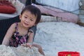 Cute baby girl enjoying sand toys on the beach. Royalty Free Stock Photo