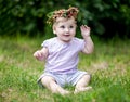 Cute baby girl with gold hair and wild strawberry crown Royalty Free Stock Photo