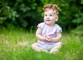 Cute baby girl with gold hair and wild strawberry crown Royalty Free Stock Photo