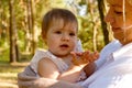 cute baby girl in her mother's arms in the park Royalty Free Stock Photo
