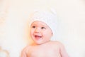 Cute Baby Girl Laughing and Wearing a Soft Knit Bear Ears Hat Royalty Free Stock Photo