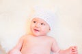 Cute Baby Girl Laughing and Wearing a Soft Knit Bear Ears Hat Royalty Free Stock Photo