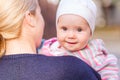 Cute baby girl looking out from mother's back Royalty Free Stock Photo