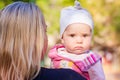 Cute baby girl looking out from mother's back Royalty Free Stock Photo