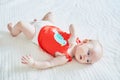 Cute baby girl lying on her back on bed Royalty Free Stock Photo