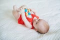 Cute baby girl lying on her back on bed Royalty Free Stock Photo