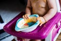 Cute baby girl makes a mess while eating, detail, blurred