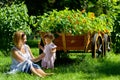 Cute baby girl with mother in a garden with flower