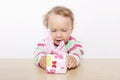 Cute baby girl opening present. Royalty Free Stock Photo