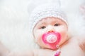 Cute Baby Girl with Pacifier Wearing a Soft Knit Bear Ears Hat Royalty Free Stock Photo