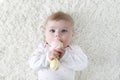 Cute baby girl playing with colorful pastel vintage rattle toy Royalty Free Stock Photo