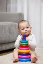 Cute baby girl playing with colorful toy pyramid Royalty Free Stock Photo